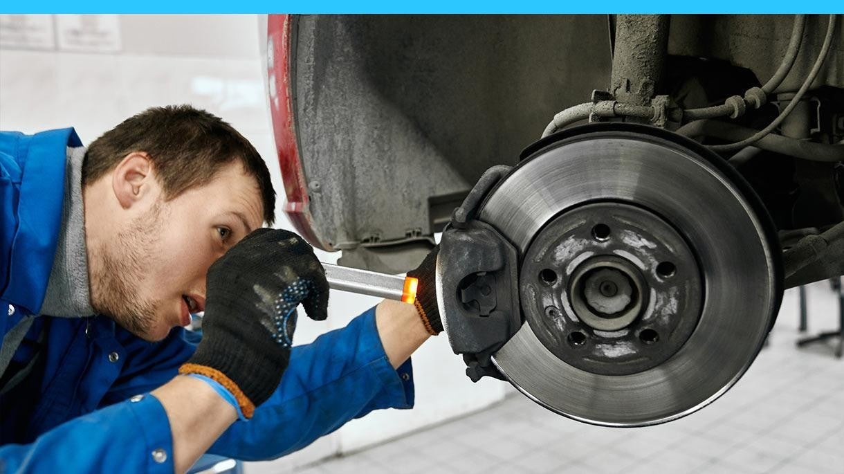 Service technician checking brake alignment