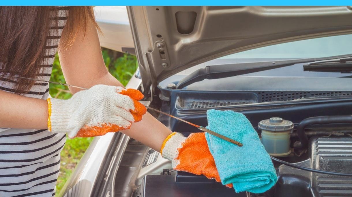 woman checking her oil