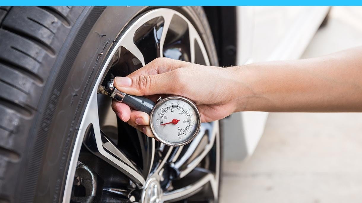 checking tire pressure using a pressure gauge