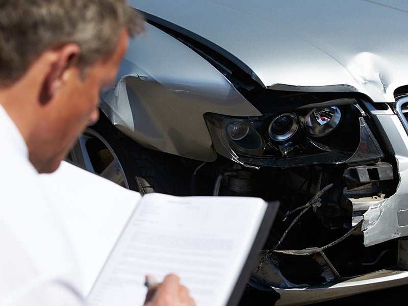 Man looking at car accident
